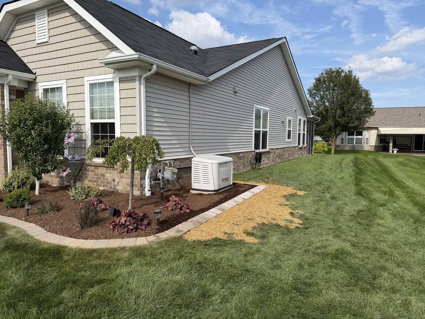 Generator bed with paver border and new plantings