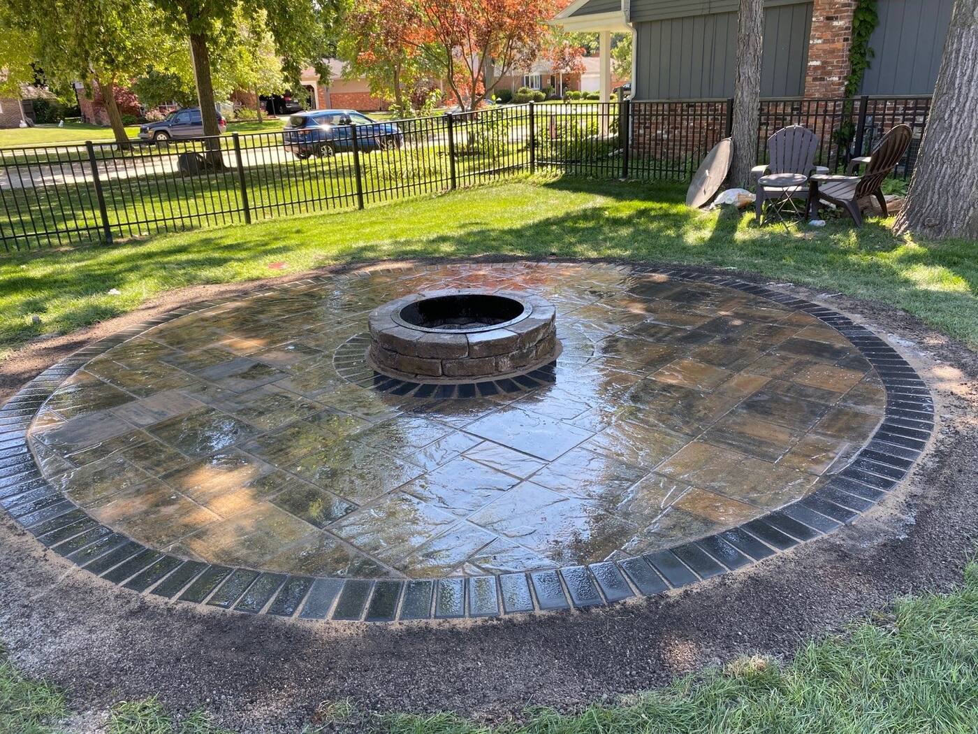 Circular paver fire pit patio with charcoal border