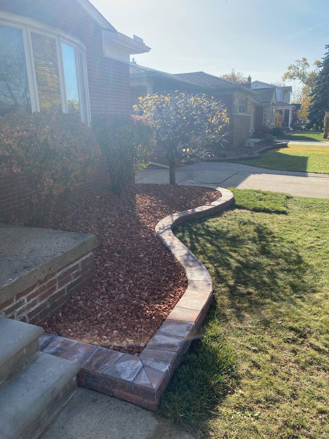 Serpentine garden wall with red rock