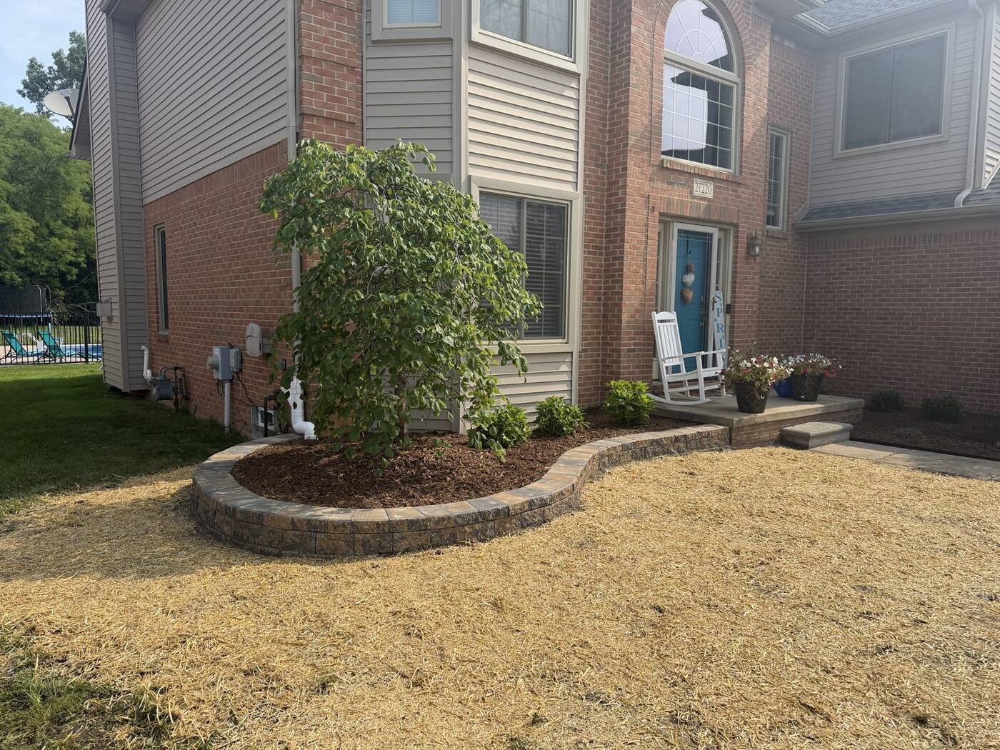 After: curved garden wall bed with weeping tree and new lawn